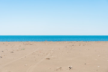 Dirty sandy beach of the Black Sea. Environmental pollution