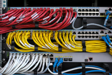 Network routers of ISP. Many wires connect to the network interfaces of powerful Internet servers. Racks with computer equipment in the server room data center.