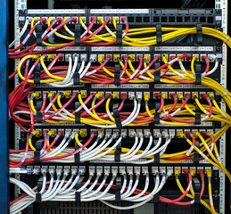 Network routers of ISP. Many wires connect to the network interfaces of powerful Internet servers. Racks with computer equipment in the server room data center.