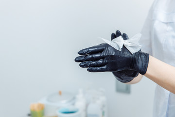How to do waxing. Womens DIY. Step 2 of 8 Disinfect your hands. On the hands of dressed black...