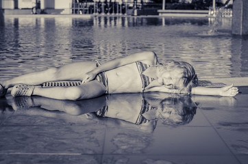 girl and her reflection in the swimming pool