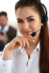 Beautiful brunette smiling call centre clerk at work