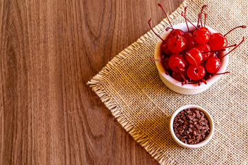 Fototapeta na wymiar Delicious cherries in bowl on wooden background