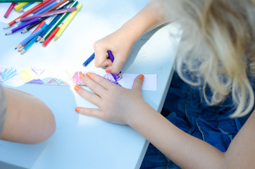 little child drawing with colorful pencils