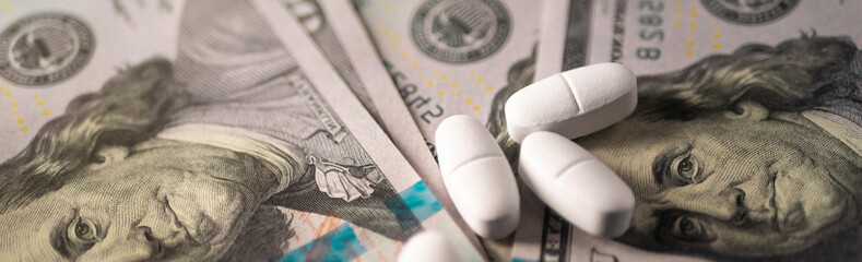 White pills and a hundred dollars. Financing the production of medicines against coronavirus Covid-19 (SARS-CoV-2), viral and bacterial infections in laboratories. Template. © Kost9