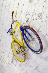 vintage bike hanging on the wall. old blue bicycle hanging on the wall