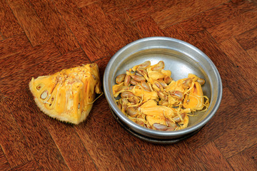 Sweet fresh tasty jack fruits in a vessel isolated on wooden background