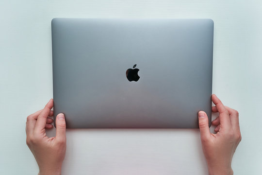Batumi, Georgia - May 04, 2020. Macbook Pro 16 inch model of space gray color of Apple brand in hands on a white background released in 2019