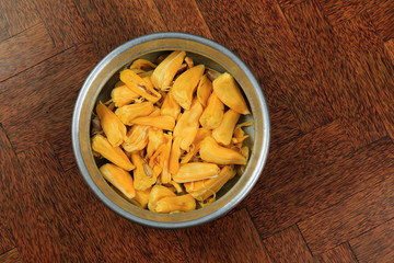 Sweet fresh tasty jack fruits in a vessel isolated on wooden background