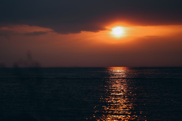 Fototapeta premium Beautiful orange sunset seaside dark colors