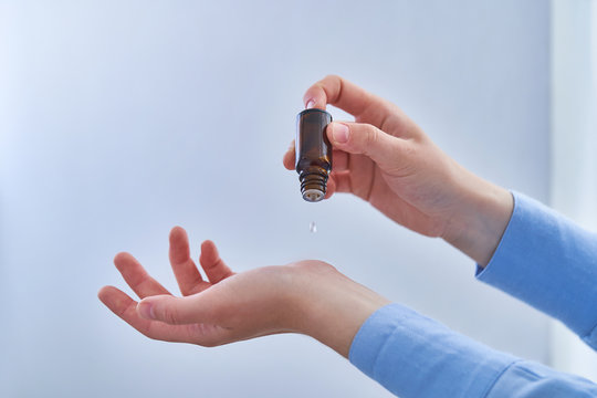 Woman applying natural essential perfume oil on the wrist