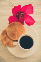 fresh homemade round waffles with hot drink in cup