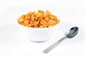close up of muesli with dried fruits and yogurt in bowl on white background