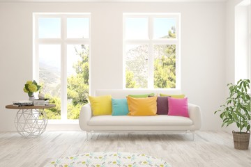 White living room with sofa and summer landscape in window. Scandinavian interior design. 3D illustration