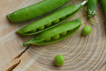 New harvest of fresh ripe green peas. legumes.Green peas and pea pods on wooden background.Close-up