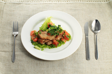 close up of potato with chicken with vegetables and salad on plate