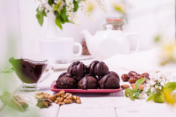 Energy balls with chocolate on a white wooden background. Raw food diet, veganism. Healthy...