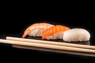 Simple sushi nigiri maki set isolated on black background. Various selection of traditional japanese