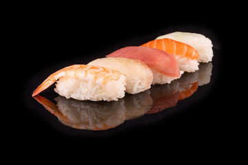 Simple sushi nigiri maki set isolated on black background. Various selection of traditional japanese