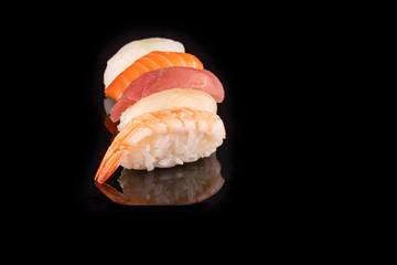 Simple sushi nigiri maki set isolated on black background. Various selection of traditional japanese