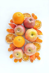 Fruit composition of oranges and apples on a white background, flat lay