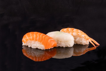 Simple sushi nigiri maki set isolated on black background. Various selection of traditional japanese