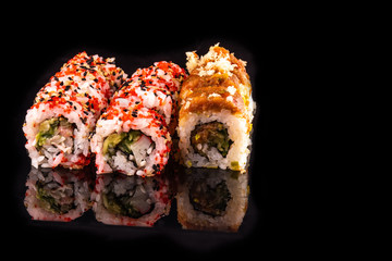 Simple sushi nigiri maki set isolated on black background. Various selection of traditional japanese