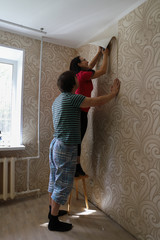 renovation in a new apartment by new residents, tear the Wallpaper off the wall