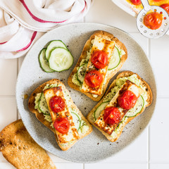 Avocado, Fried Cheese, Cucumber and Tomato Toasts