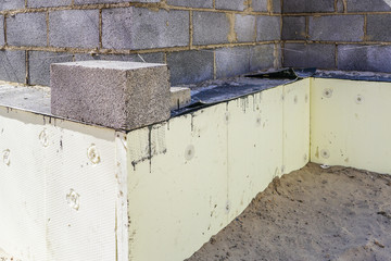 construction of a new residential house from building blocks, insulation of foundations
