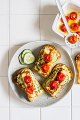 Avocado, Fried Cheese, Cucumber and Tomato Toasts