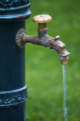Close-up of old-style column with drinking water in public park, selective focus