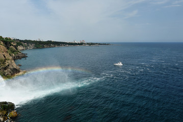 Rainbow waterfall flowing into the sea