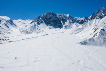 Fototapeta na wymiar Aerial drone Gudauri ski resort in winter. Caucasus mountains in Georgia