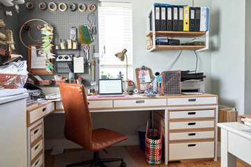 Laptop on desk in creative home office