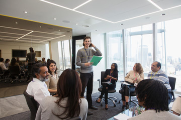 Smiling businessman leading meeting in office