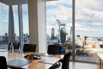 Modern conference room overlooking highrise buildings and city