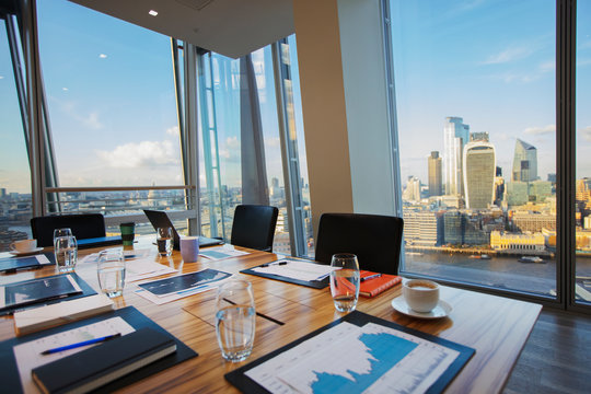 Modern conference room overlooking highrise buildings and city