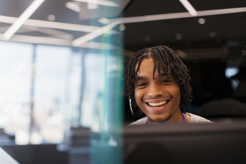 Portrait smiling businessman with headset at computer