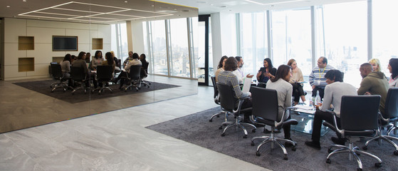 Business people in circle in conference room meeting