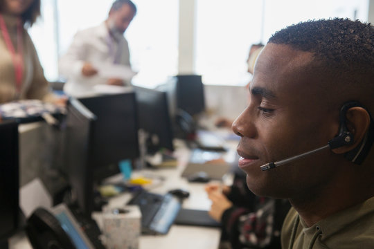 Businessman with headset working in office