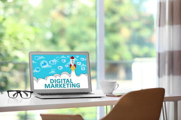 Fototapeta premium Digital marketing concept. Modern laptop on table indoors