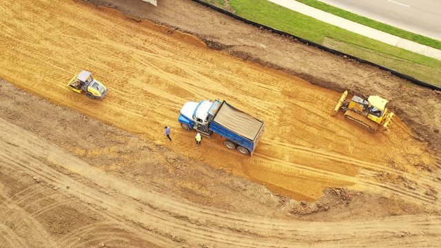 Dump Truck Dumping Fill Dirt on a Construction Site, Bryan, Texas, USA