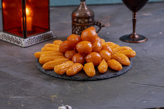 Arabic Cuisine: Middle Eastern traditonal dessert/Ramadan dessert "Balah Al-Sham" or "Balah El Shaam" served with honey syrup and pistachio. Close up with copy space.