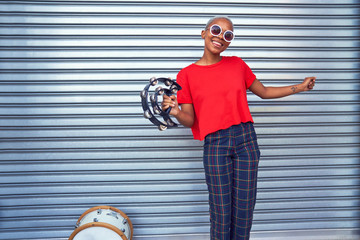 Portrait happy young female musician with tambourine