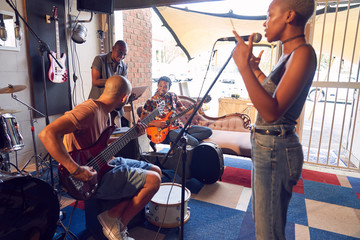 Musicians practicing in garage recording studio