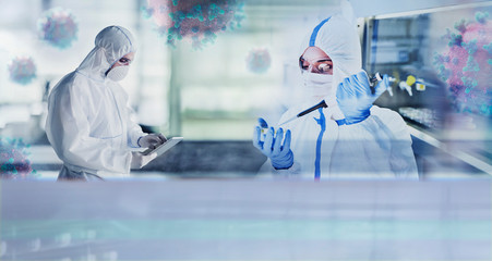 Scientists in clean suits studying coronavirus in laboratory