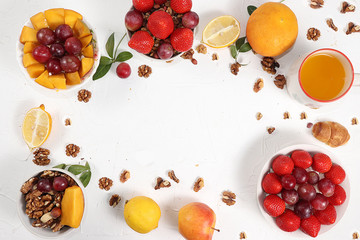 Healthy breakfast, food for children, yogurt with granola and strawberries, mango and grapes on a light table. The concept of a healthy and natural diet, lifestyle. selective focus