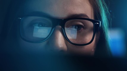 Close up of tired woman using chat got ai and working at night on laptop, girl in eye glasses with reflections overworking busy, using computer in dark office - Powered by Adobe