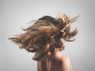Girl tosses hair in motion blur 